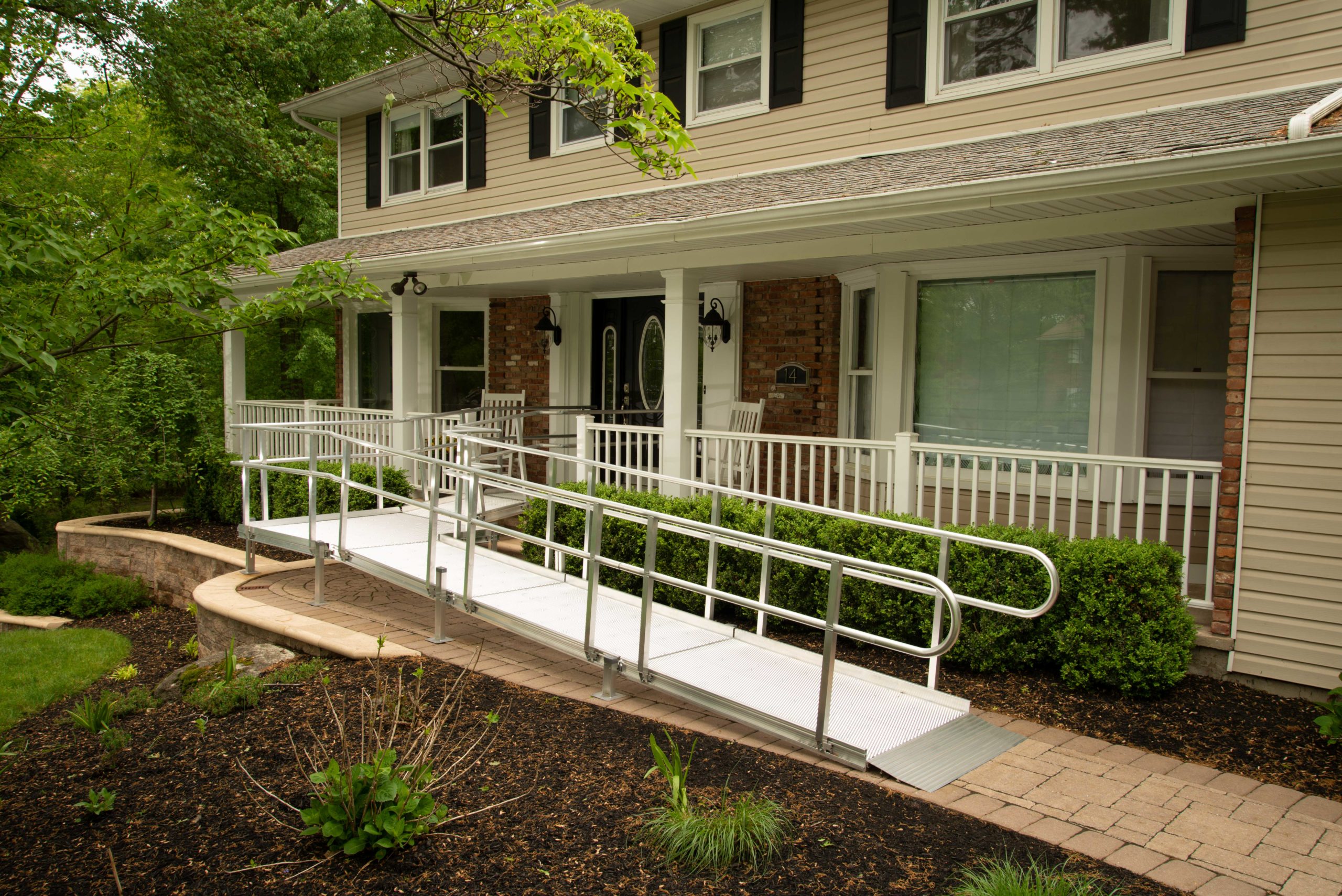 A wrap-around metal ramp for wheelchair accessibility.