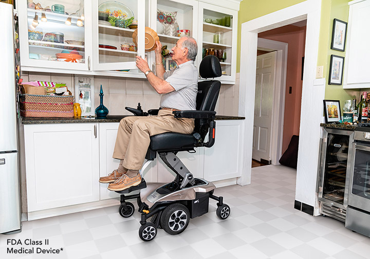 An electric wheelchair that has a rising seat for easy access to high places in the home.