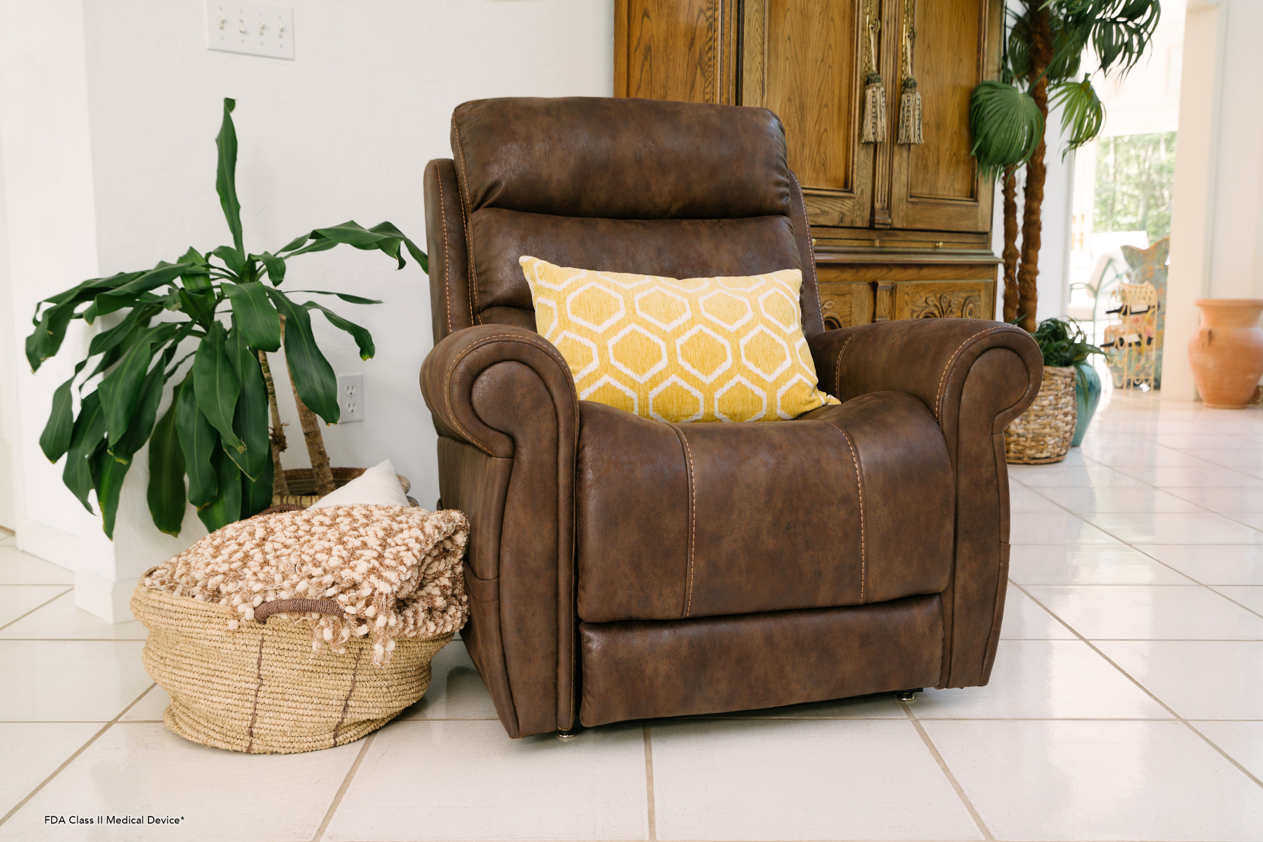 An adjustable, leather lounge chair with a yellow pillow on it.