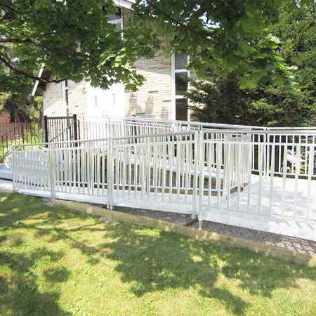A wrap-around metal ramp for wheelchair accessibility.