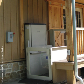 A vertical wheelchair lift installed into the deck of a home.
