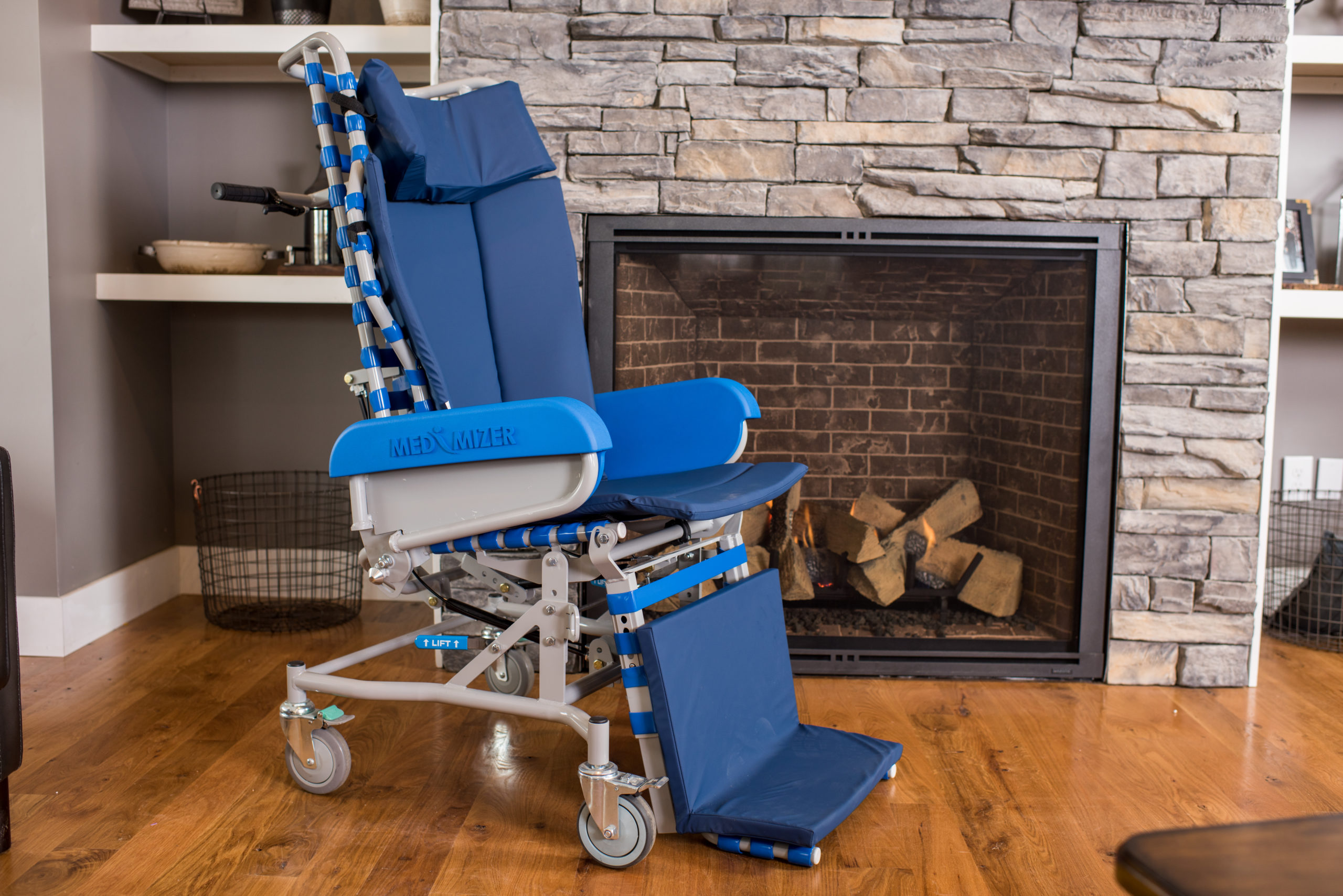 A wheelchair with a long back and head pads in blue.