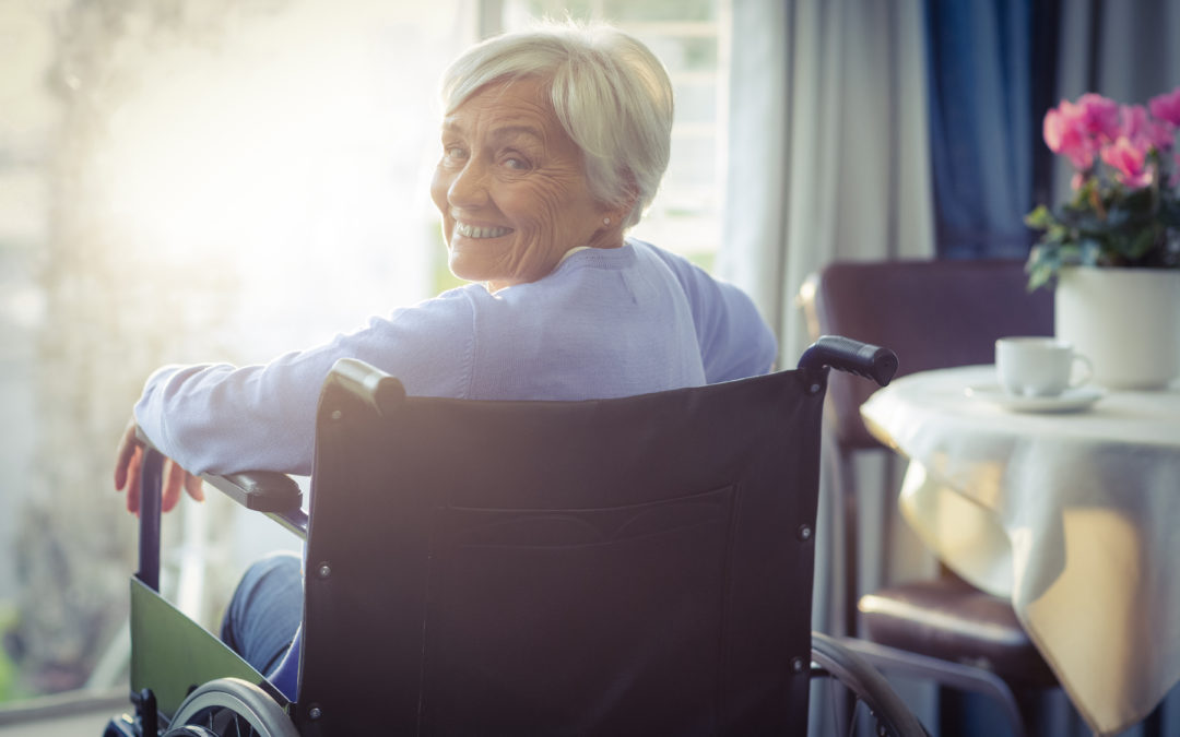 woman in a wheelchair smiling in her home