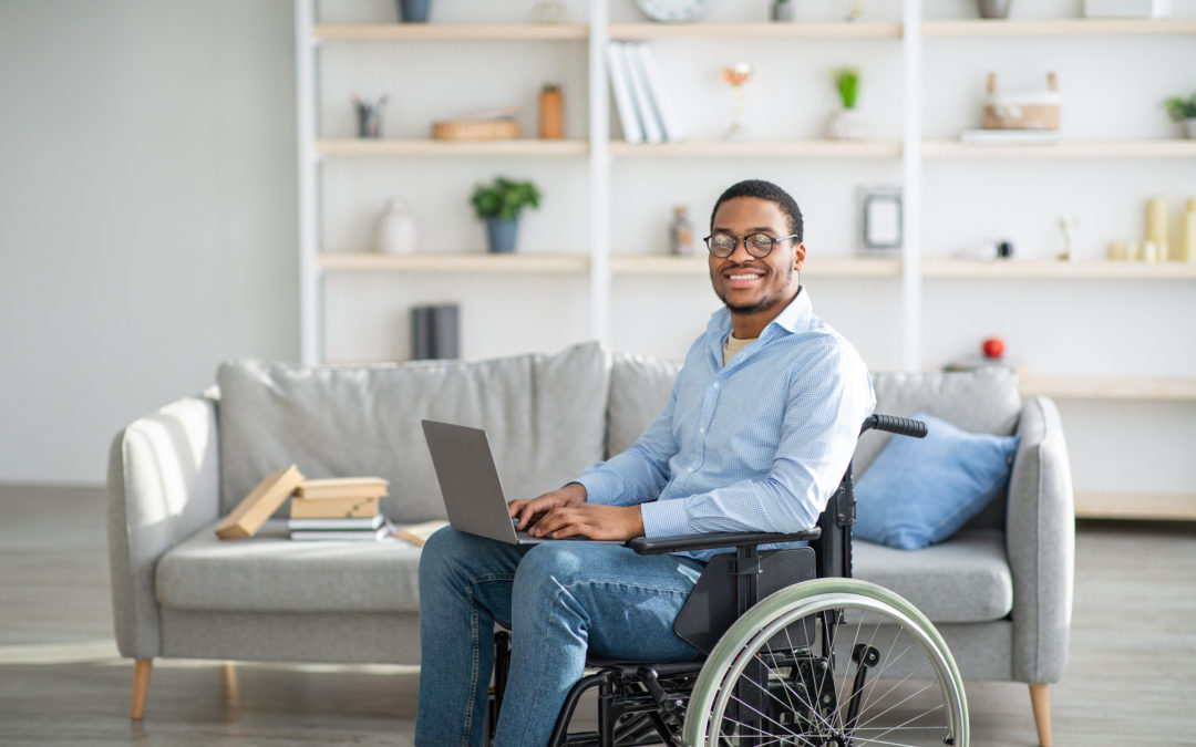man in wheelchair sitting in home